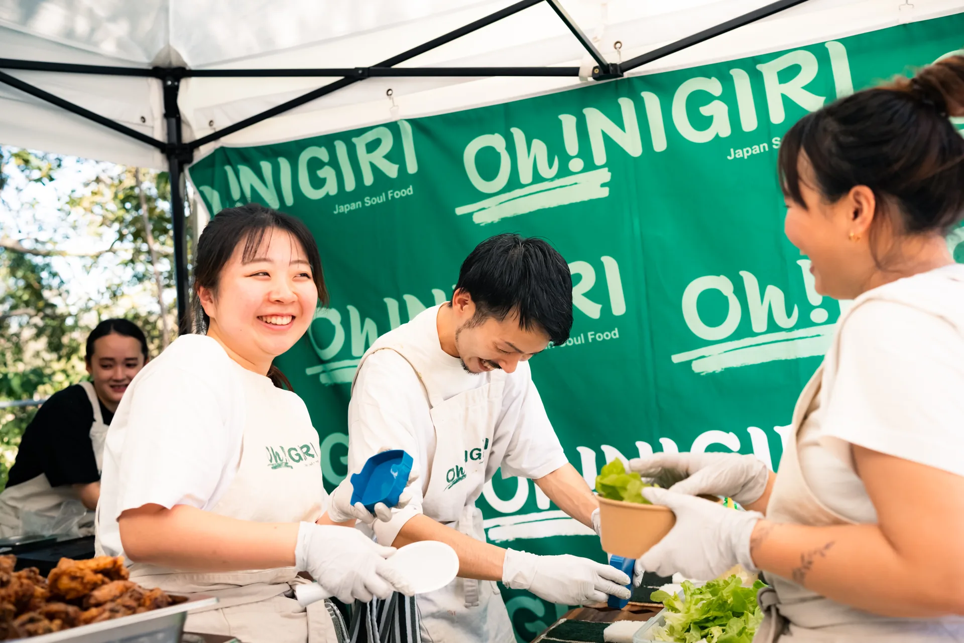 Oh!NIGIRI team preparing and handing over a fresh rice bowl