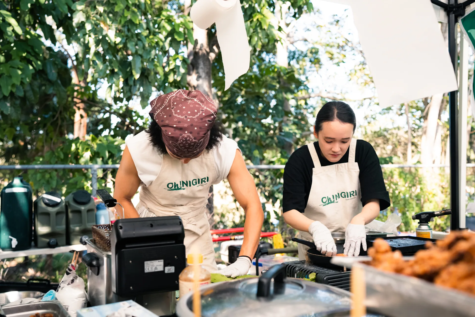 Two Oh!NIGIRI team members preparing food at the market kitchen