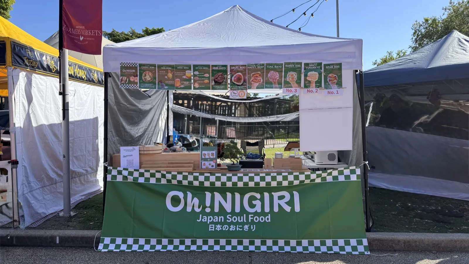 Oh!NIGIRI market stall set up with menu boards across the counter