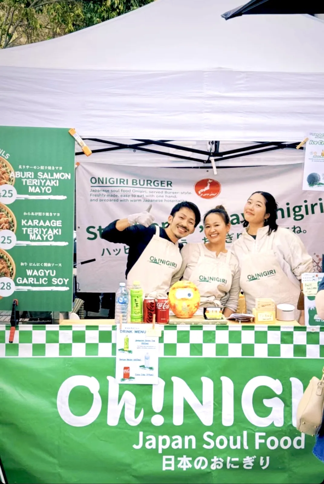 Oh!NIGIRI team smiling together behind the market counter