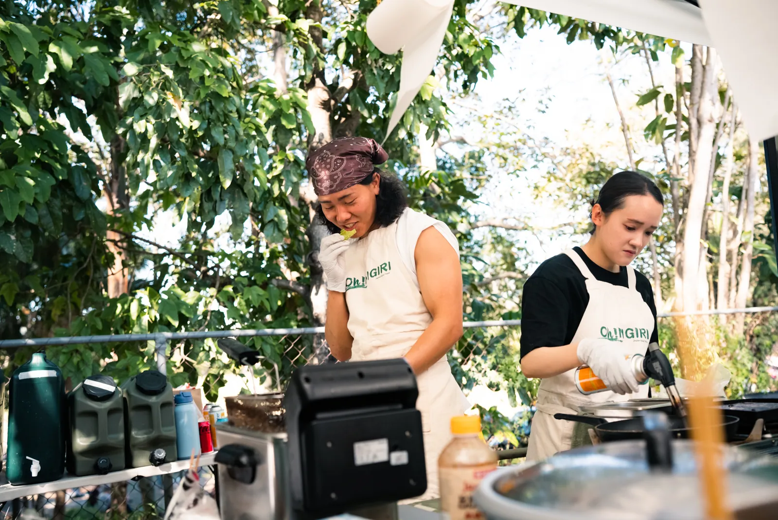 Two Oh!NIGIRI team members cooking at the stall