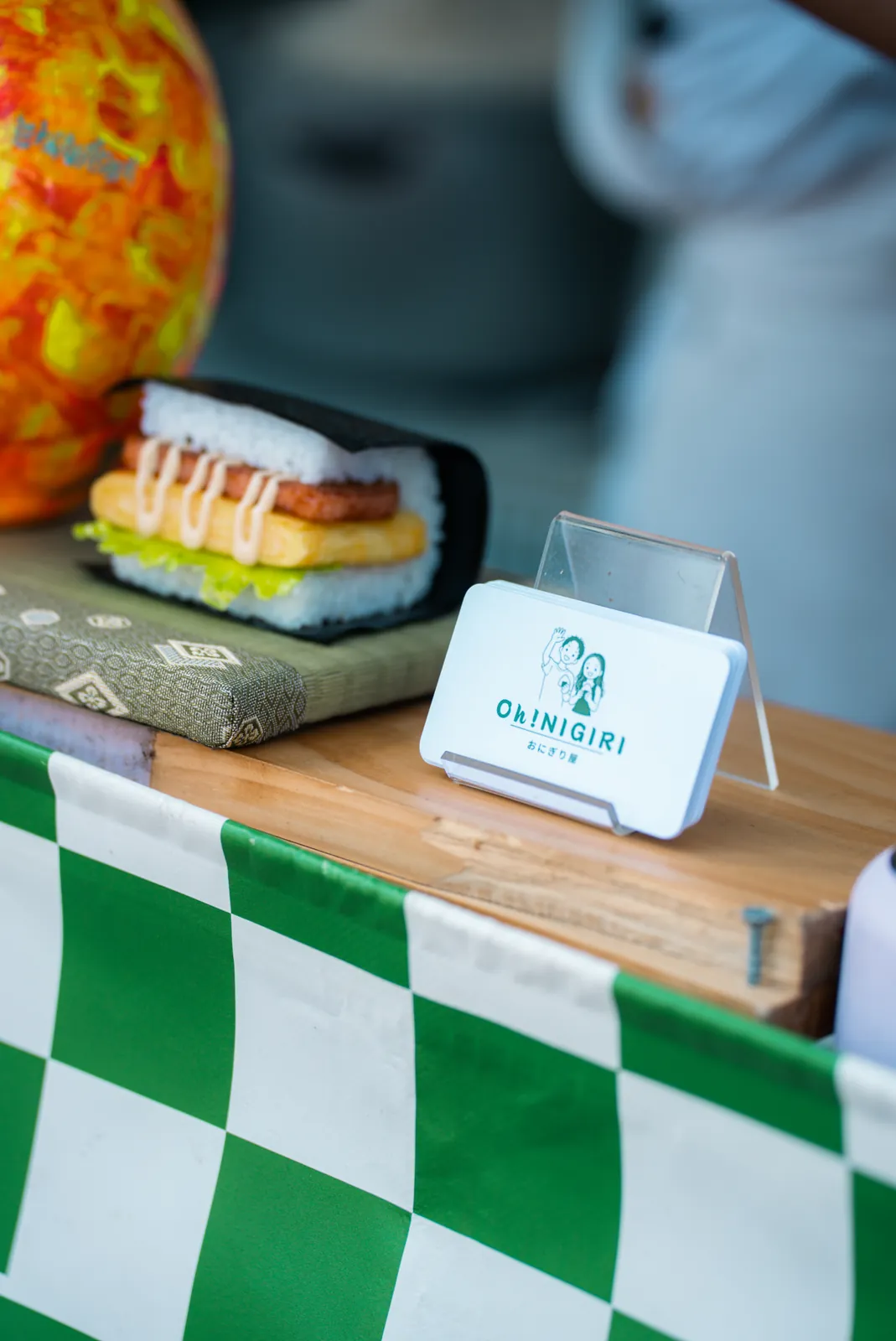 Oh!NIGIRI rice burger displayed beside the stall logo