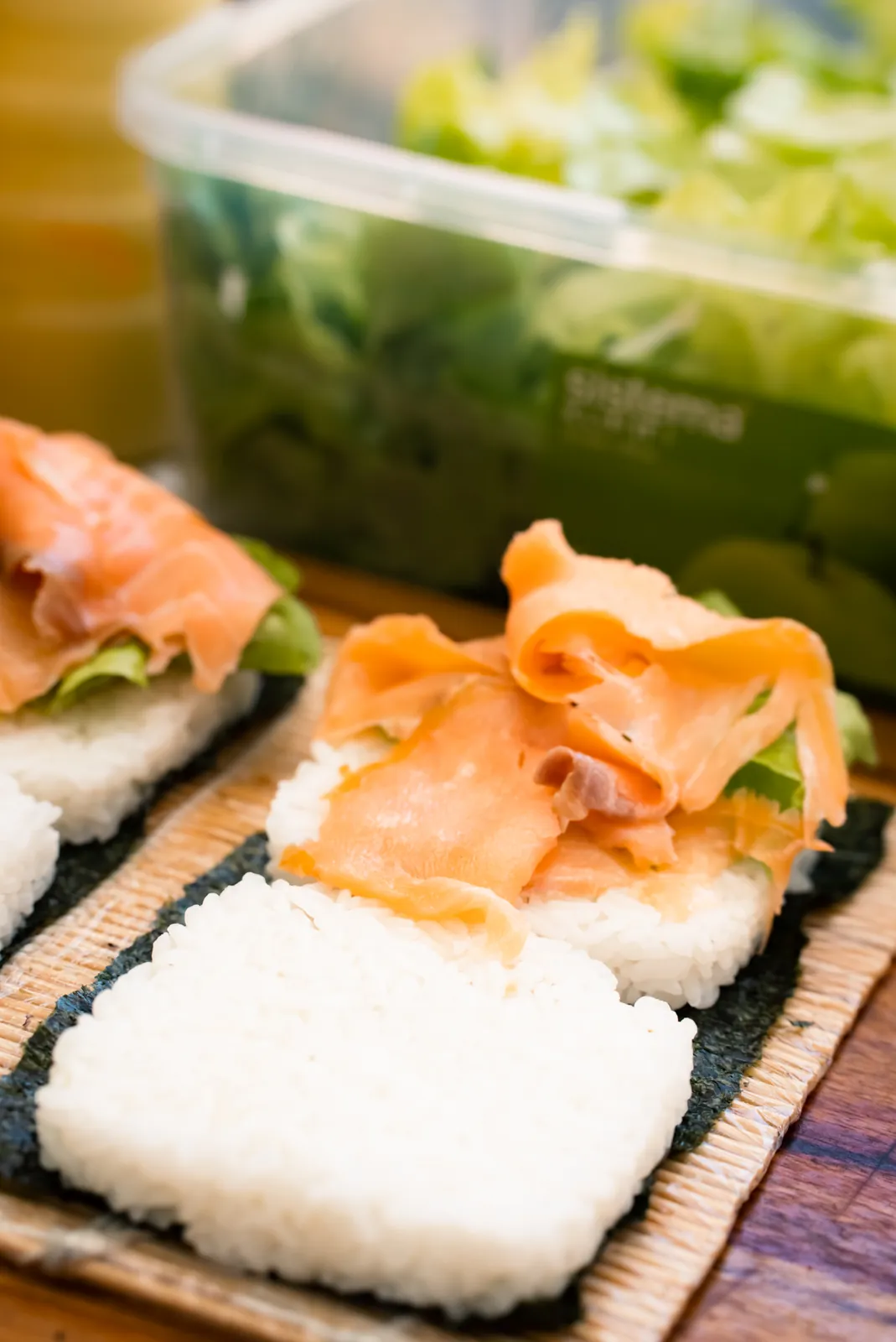 Smoked salmon layered onto rice burger bases