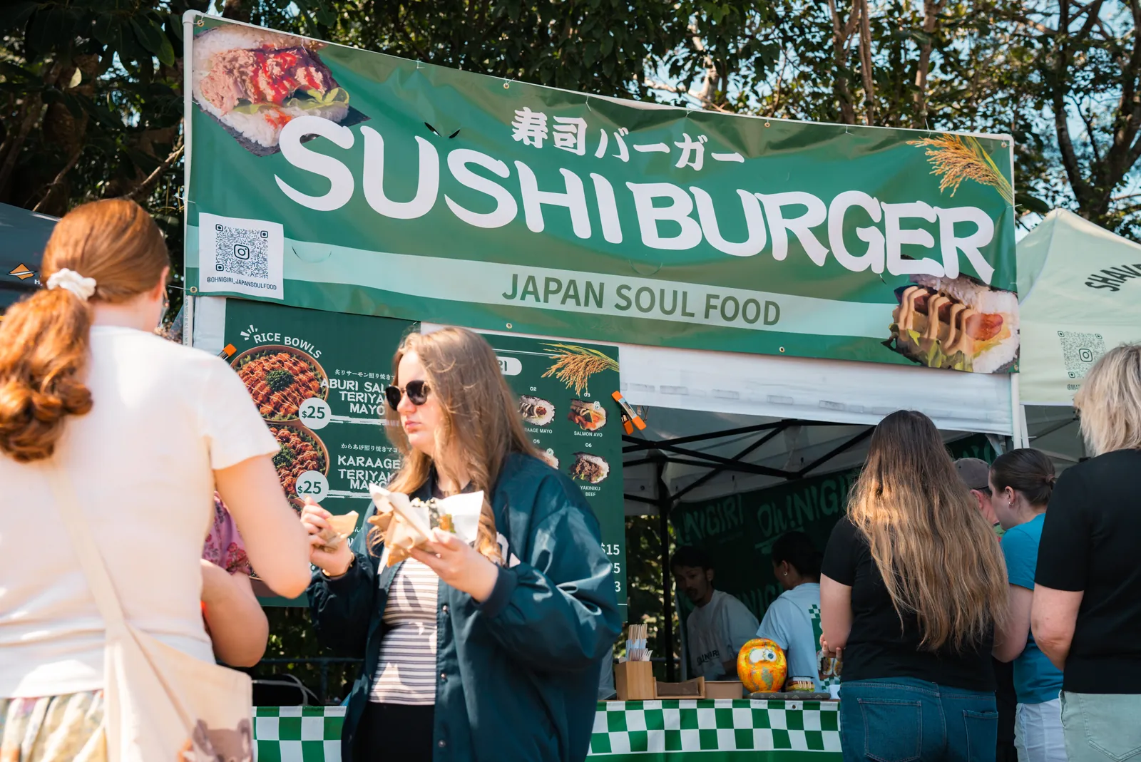 Oh!NIGIRI stall and visitors eating nearby at the market