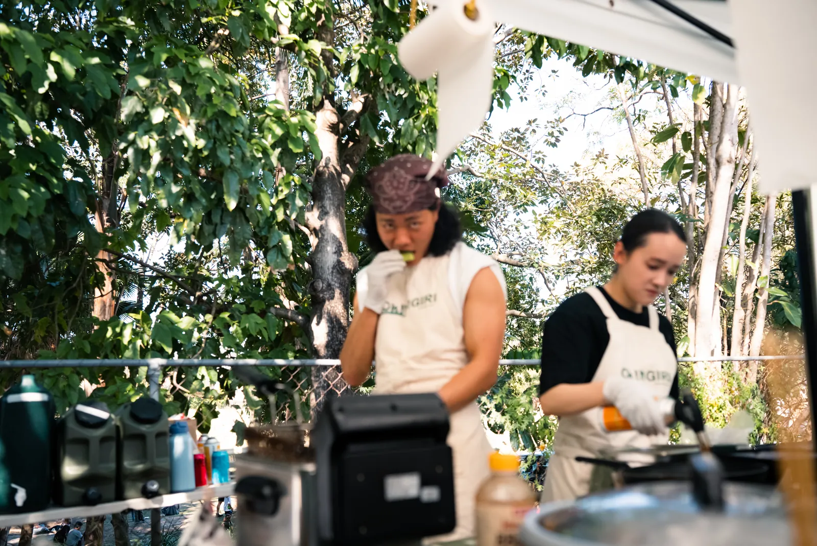 Two Oh!NIGIRI team members cooking inside the stall
