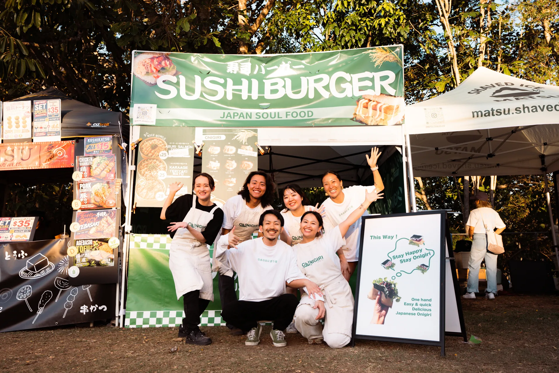 Six Oh!NIGIRI team members in front of the complete market stall