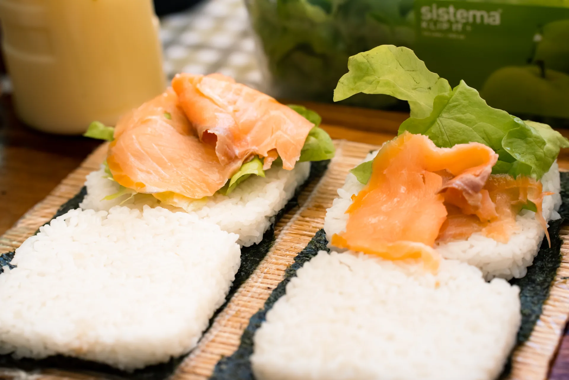 Smoked salmon and lettuce arranged on rice burger bases