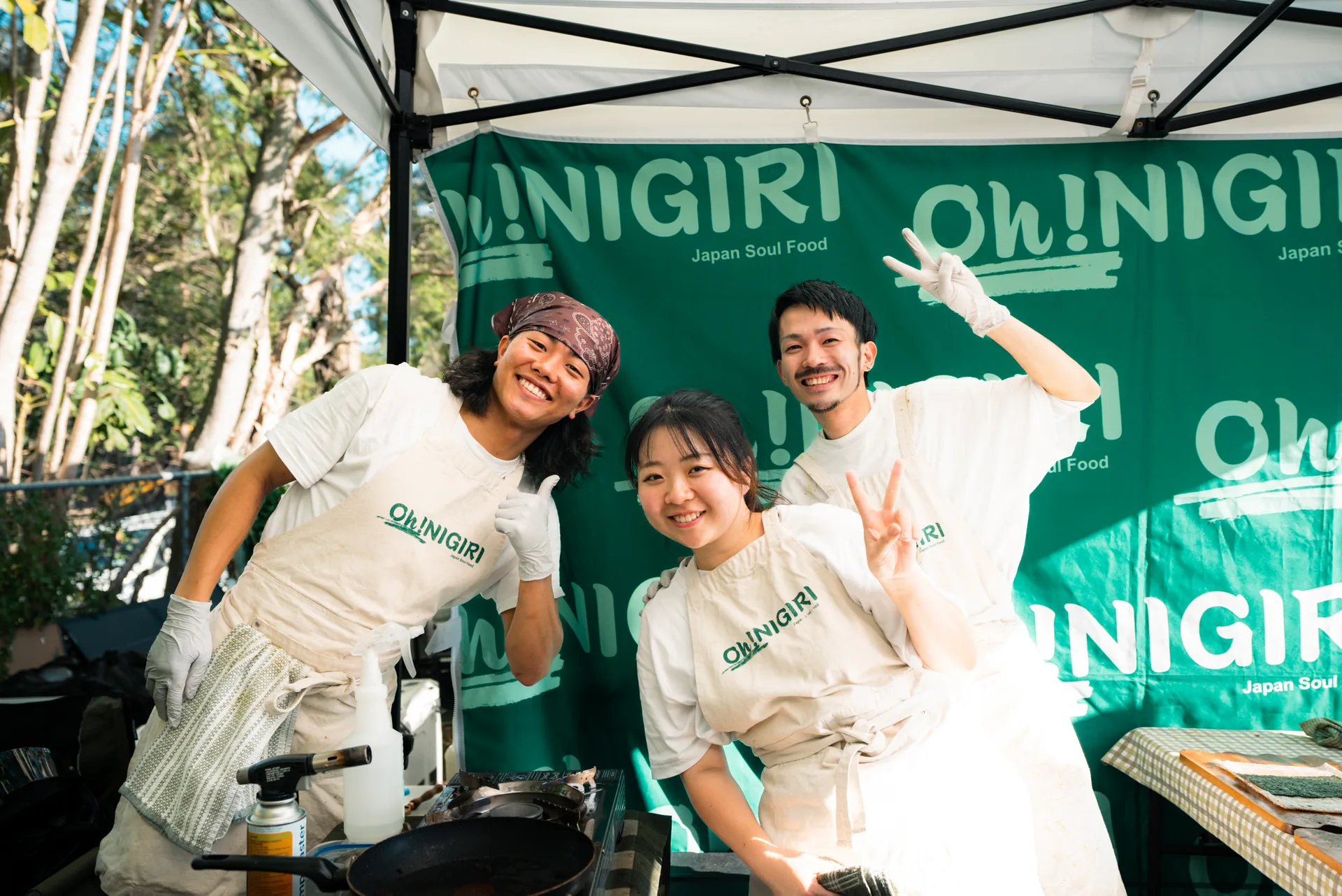 Three Oh!NIGIRI team members together inside the branded stall