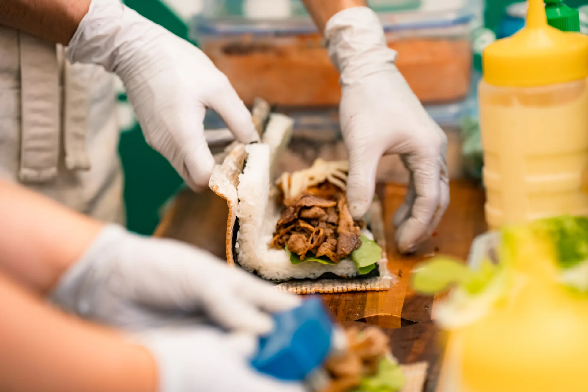 Oh!NIGIRI rice burger being assembled with rice, nori and filling