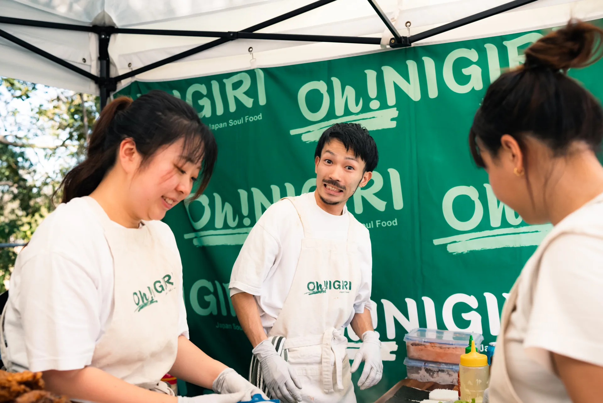 Oh!NIGIRI team preparing food together inside the market stall